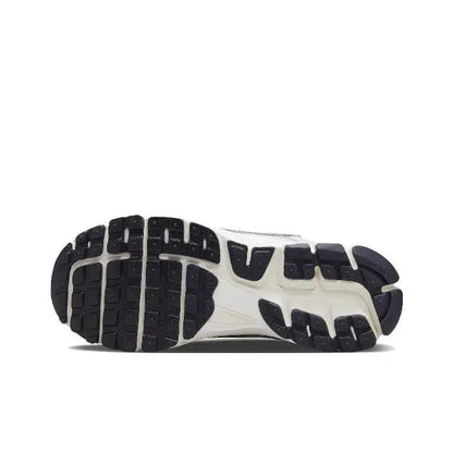 Light gray running shoe outsole with tread pattern and dark rubber segments