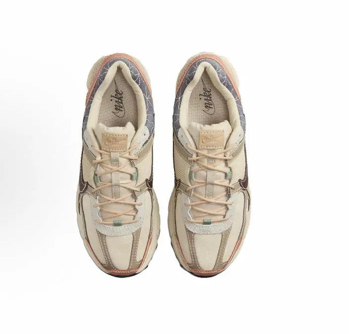Nike Zoom Vomero 5 SP sneaker pair, beige uppers with lace-up closure and cushioned collar