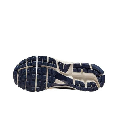 Nike running shoe outsole, textured blue and off-white tread with gray stripes