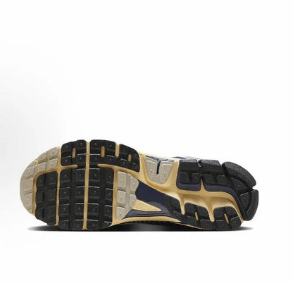 Nike running sneaker outsole with dark tread and tan sidewall trim