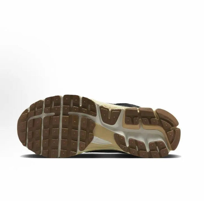 Nike running shoes outsole view, brown tread with off-white midsole edge