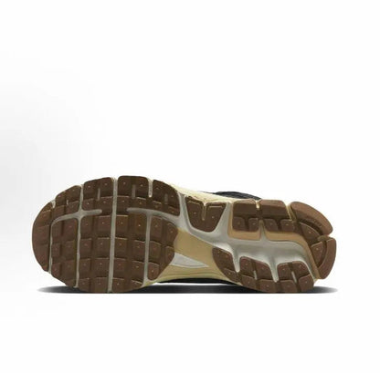 Nike running shoes outsole view, brown tread with off-white midsole edge