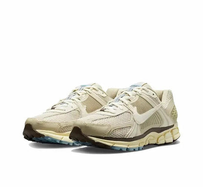 Oatmeal lace-up sneakers with Nike swoosh, textured panels, and blue midsole