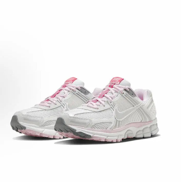 Running shoe, white with pink laces, front side angled view