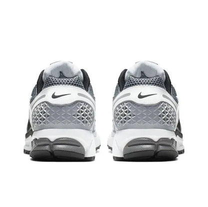 Back view of black, white and dark grey running sneakers with heel cushioning