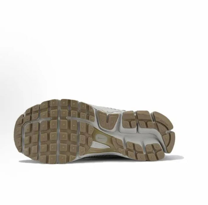 Gray running sneaker outsole with traction tread and molded midsole sidewalls