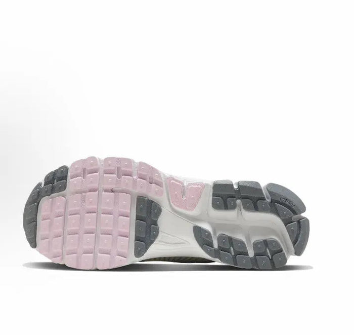 Running shoe outsole, light gray with pink tread and dark rubber sections