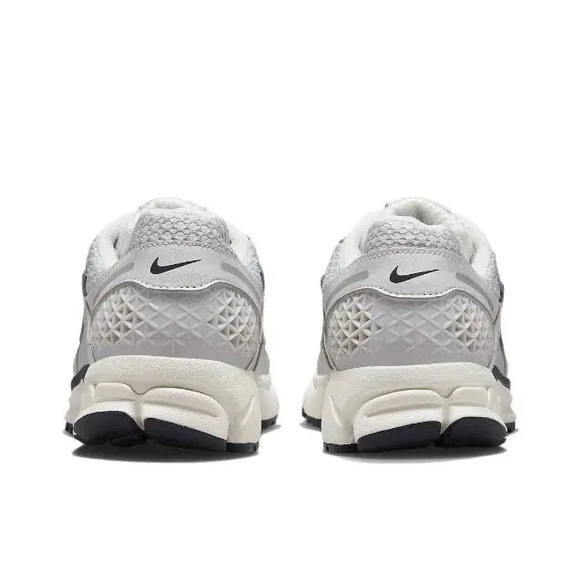 Light gray running shoes back view with Nike heel logo and cushioned collar