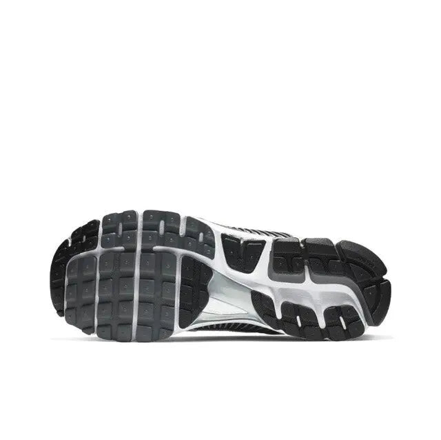 Black and white running sneaker outsole with tread pattern