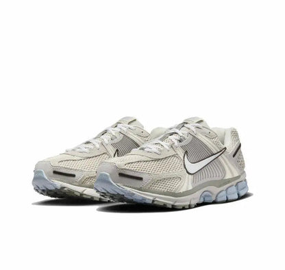 Nike Zoom Vomero 5 SP running shoe side view, light beige mesh with blue sole