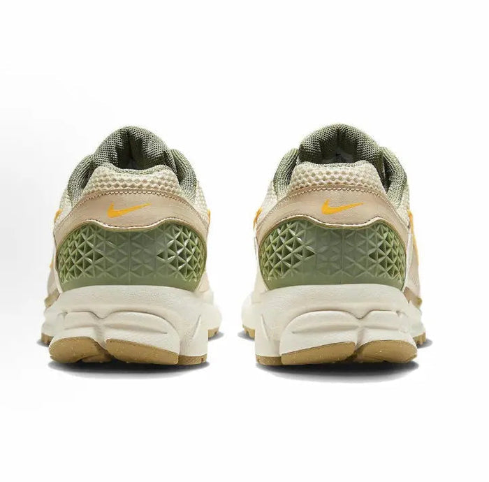 Nike Zoom Vomero 5 SP heel view sneakers in pale ivory with green cage panels
