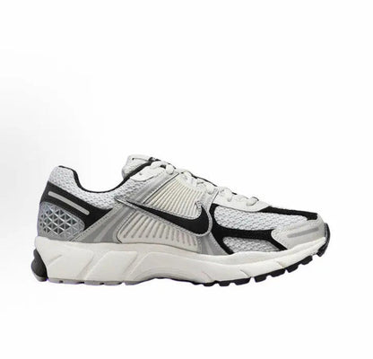 Running sneaker in light gray with black swoosh, textured panels, lace-up