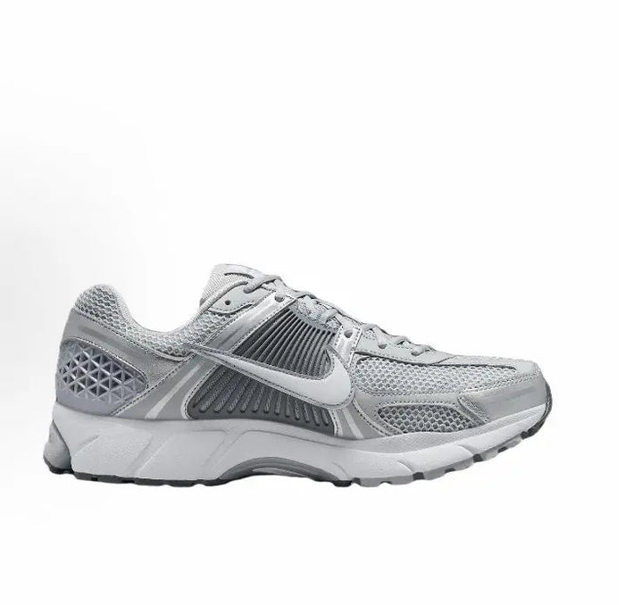 Running shoe side profile, light grey mesh with striped midfoot panel and rubber sole