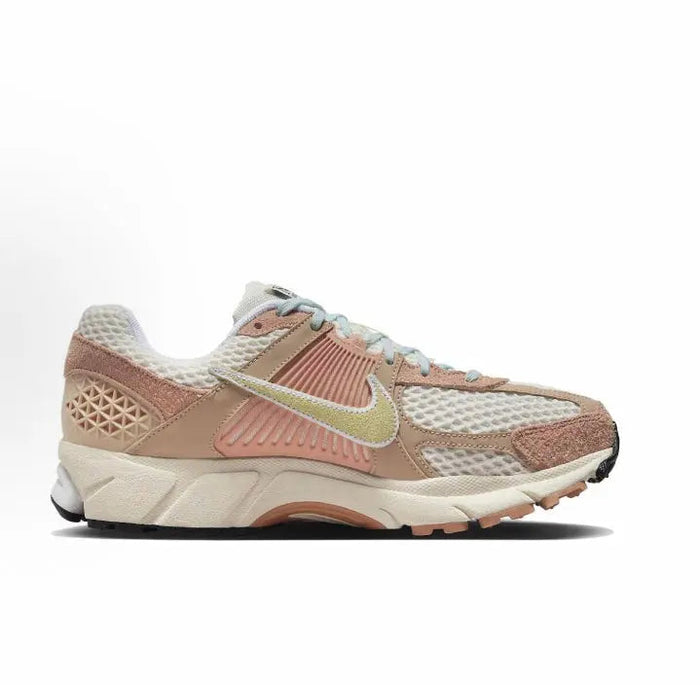 Nike Zoom Vomero 5 SP sneaker angled side view in tan, pale aqua, and pink accents