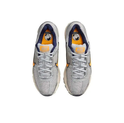 Nike running shoe top view, light gray mesh with orange accents and blue inner lining
