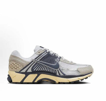 Nike running sneaker in light gray with navy side stripes and tan midsole cushioning