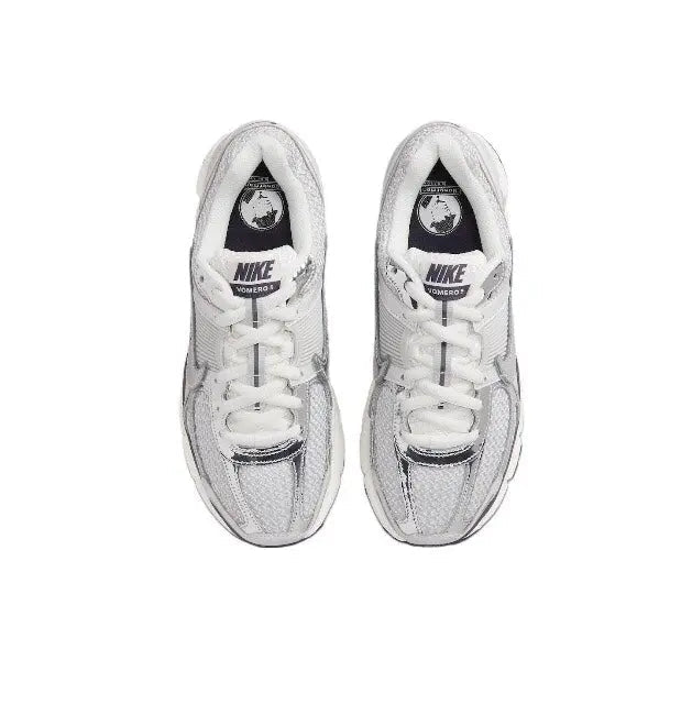 Light gray running shoes top view, white laces, Nike tongue logo