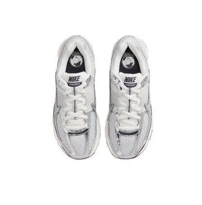 Light gray running shoes top view, white laces, Nike tongue logo