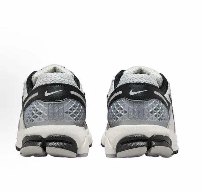 Running sneaker heel view with Nike logo, gray cushioning, and black heel accents