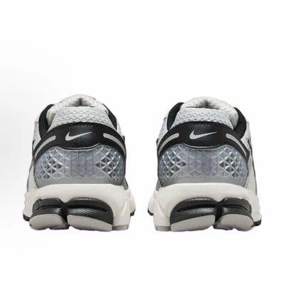 Running sneaker heel view with Nike logo, gray cushioning, and black heel accents