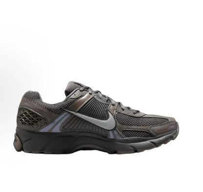 Running shoe side view in dark gray with silver stripe and padded collar