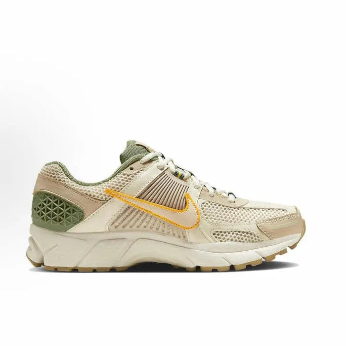 Nike Zoom Vomero 5 SP side profile sneakers, pale ivory with green heel and orange swoosh